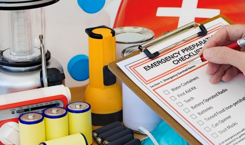 Hand completing Emergency Preparation List by Equipment