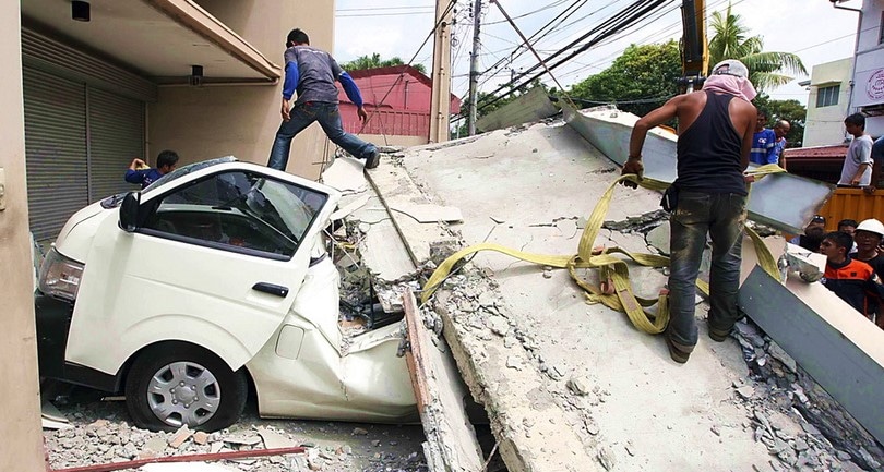 Car after buildings collapsed during an earthquake