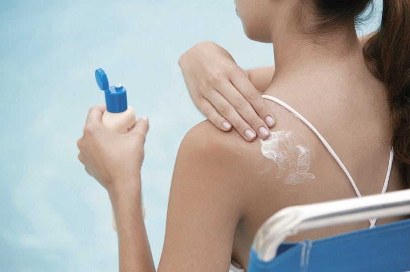 Woman applying protective sunscreen