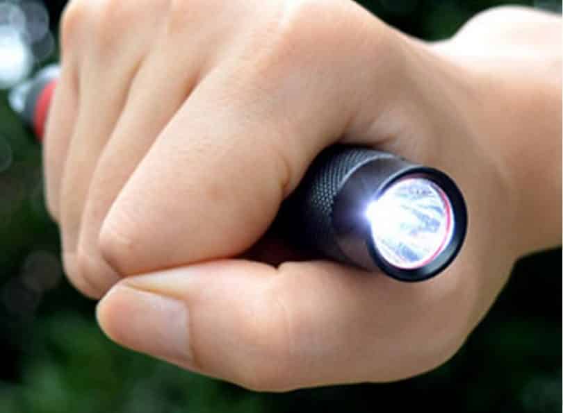 led survival flashlight in the hand